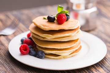 Close-up delicious pancakes with fresh blueberries and raspberries.