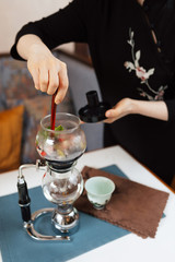 Tea siphon. Brewing purple flower tea in a siphonpurple