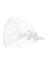 Detailed shot of a white mesh veil decorated with shimmering pearls. The stylish veil with straps tied in a bow is located on the white backdrop.