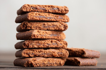Chocolate home made cookies on the wooden table. Stacked chocolate chip cookies close up