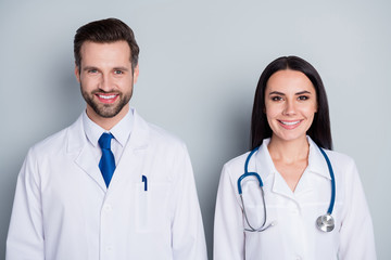 Fototapeta premium Photo of handsome doc guy practitioner professional pretty lady two people patients consultation virology clinic listen client complaining wear lab coats isolated grey color background