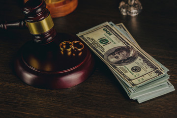 Close-up Of Wedding Rings And Wooden Gavel.