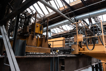 Old disabled heavy industry factory machinery inside low angle shot