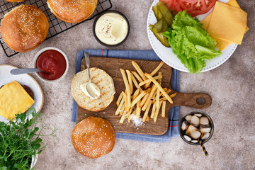 Burger with french fries and ingredients. Top view.
