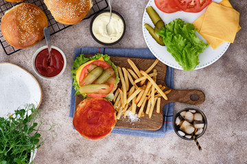 Burger with french fries and ingredients. Top view.
