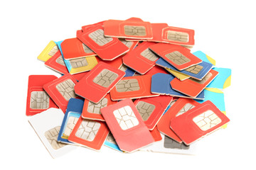 A bunch of different sim mobile phone cards are isolated on a white background. Digital chips for...