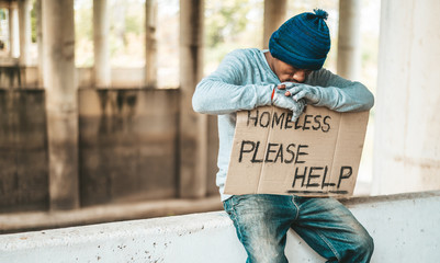 Beggars sit on barriers with homeless Please help messages.