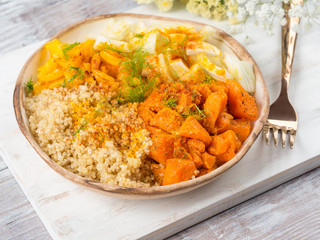 Vegan quinoa bowl with baked spiced pumpkin, fennel, bell pepper and turmeric. Healthy gluten free lunch or dinner