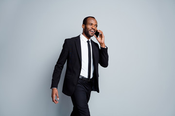 Portrait of his he nice attractive cheerful cheery content classy rich wealthy imposing guy employee agent broker banker going talking on phone negotiation isolated over grey pastel color background