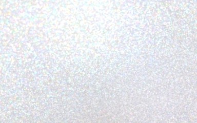 White iridescent brilliance blurred texture. Lot of small sparkles. Holiday shiny blank background.