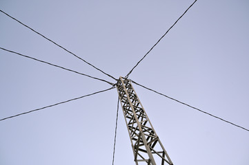 A pylon with six diagonal high voltage cables.