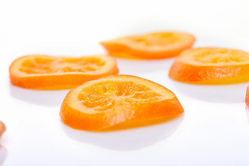 Naklejka na ściany i meble Slices Dried oranges or tangerines isolated on a white background. Vegetarianism and healthy eating