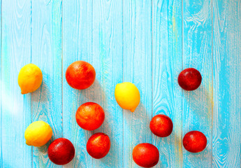 banner with red oranges and lemons on a blue wooden background. Summer concept. Fruits and vitamins. Everything for a healthy diet. Diet and Fitness