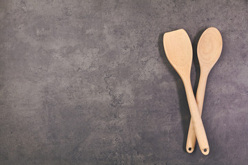 Wooden utensils over kitchen cooking table. Top view with copy space