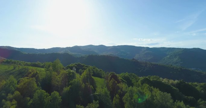 Beautiful panoramic view of forests, green hills and mountains with light blue sky