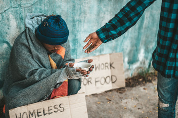 The beggars sit on the side of the road and have money..