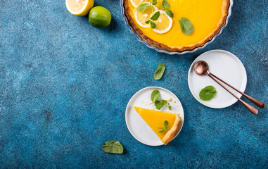 Food concept Homemade organic Lemon, lime tarts or cake  pie on blue stone board