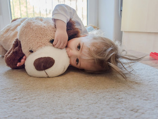 Cute boy playing with his plush toys