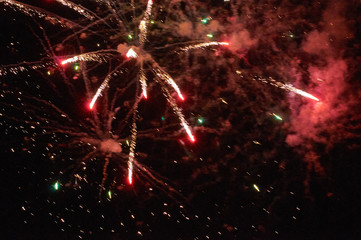 Fototapeta na wymiar Colourful fireworks on the black sky background. Holiday art background. Long exposure