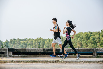 Men and women exercise by running.