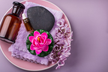 Obraz na płótnie Canvas Lilac composition for spas and Wellness centers. Towel frames and flowers.