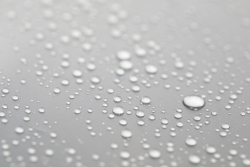 Background design made of water drops on a gray background	