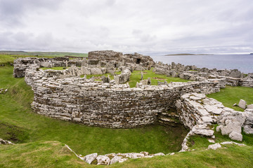 celtic prehistoric stone architecture with atlantic ocean view at Broch of Gurness in Aikerness Bay, Orkney Islands, Scotland