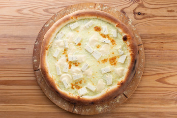 hearty italian pizza on a wooden board. hard cheese pizza