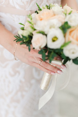 The hands of the bride. The details of the bride. Bride's bouquet. Gentle hands of the bride.
