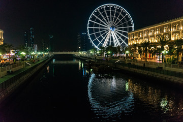 Eye of the Emirates. Illuminated Ferris wheel at night in al qasba in Sharjah | UNITED ARAB EMIRATES, SHARJAH - 17 OCTOBER 2017.