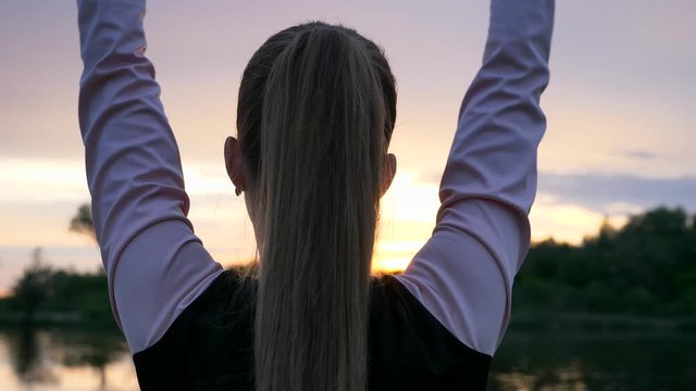 Woman Doing Exercise Warming up Workout Fitness in Grass Field. Countryside Rural Scenery. Rainy Clouds Weather Spring season. 2x Slow motion - 1/2 speed of 60 FPS.