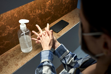 Young women disinfecting her hands, getting prepared to enter her job.