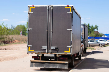 Cargo van on the side of the road, rear view. Transportation of goods. The photo