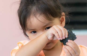 Asian girls eating seaweed snacks