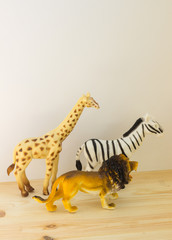 Obraz na płótnie Canvas toys lion Zebra and giraffe on a light background