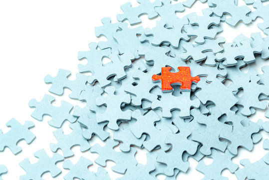 Bright Orange Puzzle Piece And Light Blue Puzzle Pieces