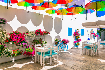 Charming bar decoration design in retro style with old bicycle,umbrellas and flowers
