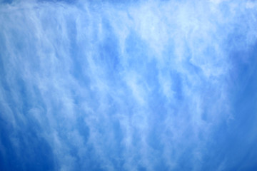 Beautiful light overcast clouds on a background of blue sky