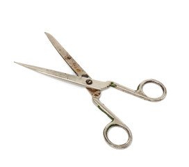 very old vintage metal tailor scissors isolated on a white background