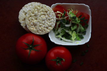 cabbage, tomato, green onion in a white plate. summer salad in a plate,  bread rolls