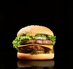Burger cheeseburger bbq sandwich with beef cheese and fresh vegetables hot with steam smoke on black