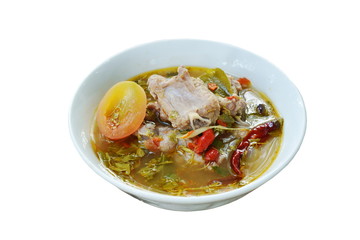hot and spicy pork bone with tamarind leaf and Thai herbs soup on bowl 