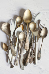 Vintage cutlery on a white background. Silver and cupronickel spoons, forks and knives.
