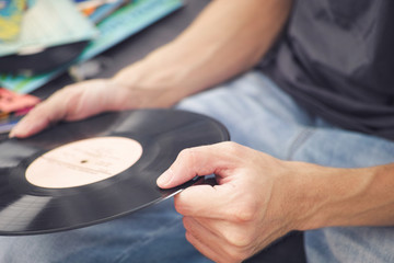 Man holding old vinyl record in his hands