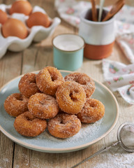 Closeup of a pile of homemade Doughnuts of easter, rosquillas, traditional anise donuts from Spain, typically eaten in Easter, on a rustic wooden table.