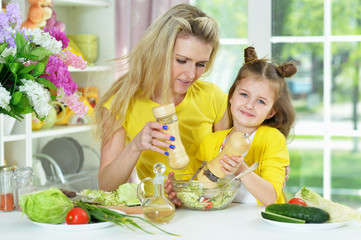 Portrait of smiling mother and daughter cooking together