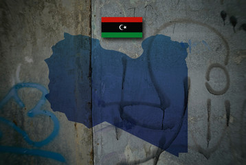 Map and flag of Libya on a dirty wooden background.