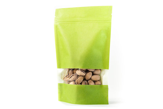 green paper standup pouch filled with dry fruit, flexible packaging with window zipper on white background