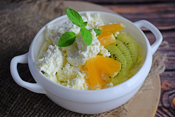 Fresh cottage cheese with fruit in a white plate.Delicious and healthy food.Healthy diet.