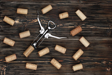 A collection of various used wine corks and corkscrew close-up. Plenty of sloping caps from alcoholic beverages